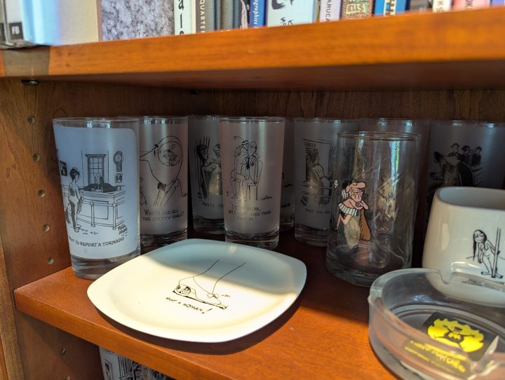 Among other things on this shelf are glasses with art from New Yorker artists, including Peter Arno