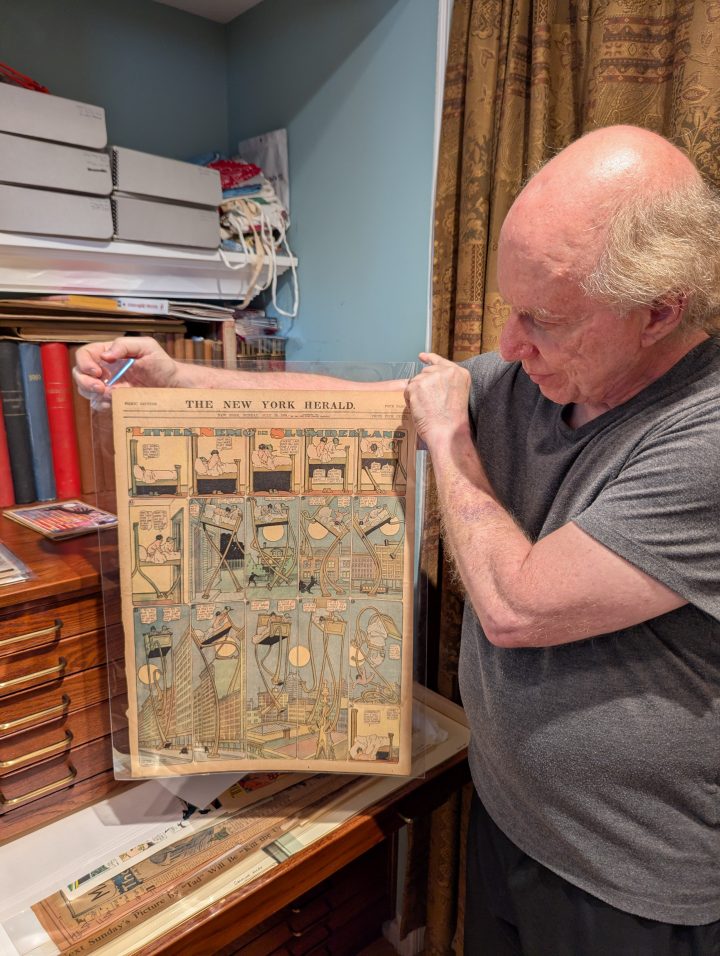 Warren holds up a Little Nemo strip from the New York Herald, July 26, 1908.