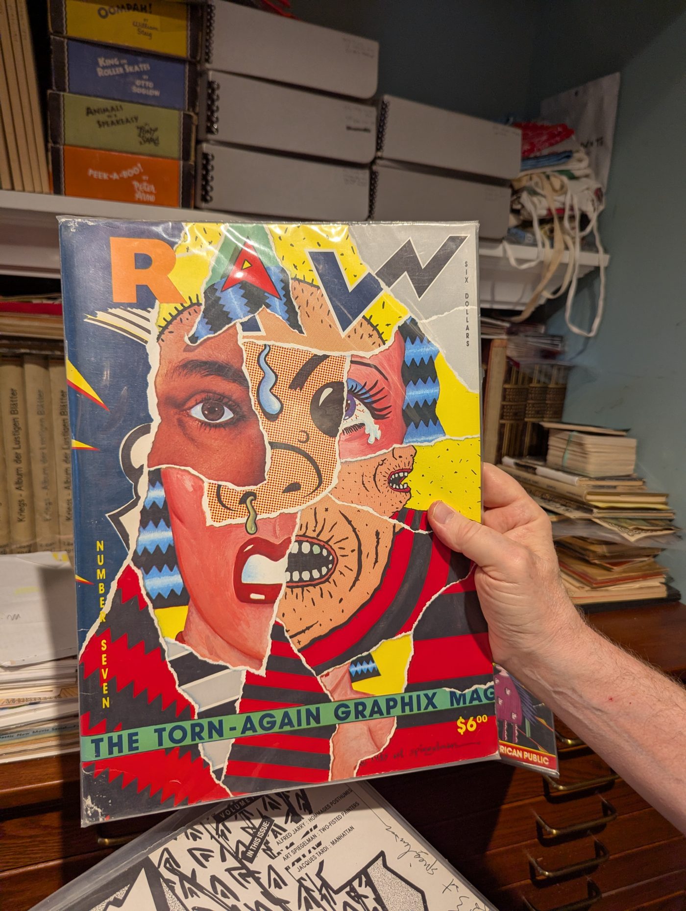 The infamous RAW issue seven. "The torn-again graphix magazine." Every copy had a piece torn off and taped inside. But not necessarily from the same copy it was torn from!
